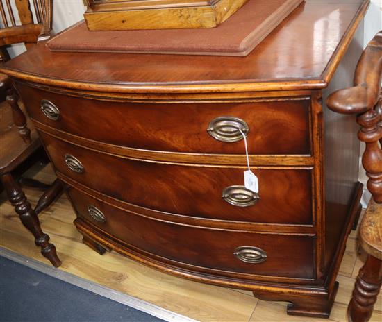 A late 19th century mahogany bowfronted chest of three drawers, with crossbanded top W.92cm